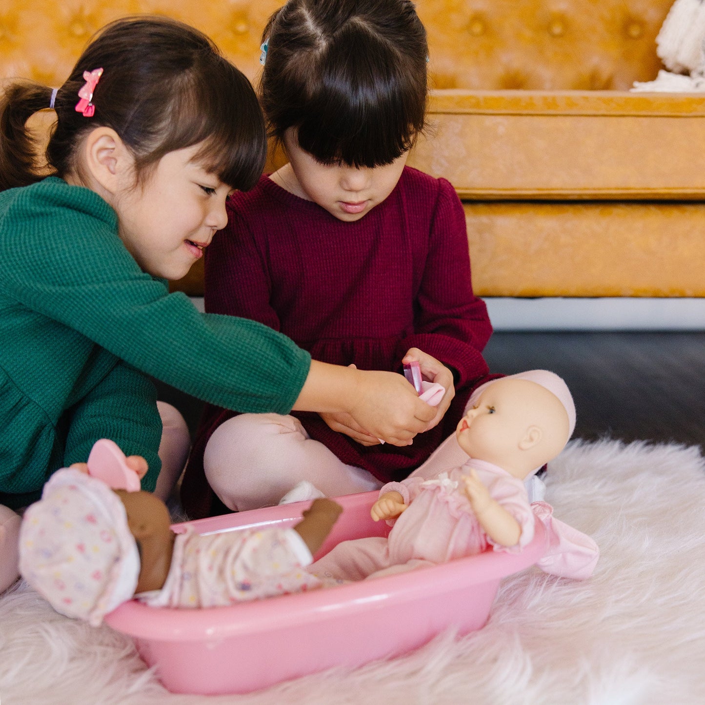 A kid playing with The Melissa & Doug Mine to Love Baby Doll Bathtub and Accessories Play Set (6 pcs)